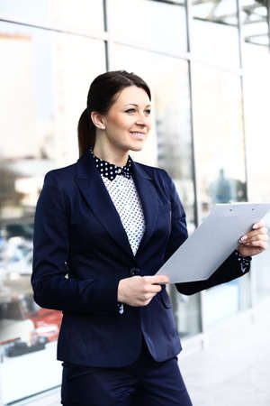Young business woman in the big city purposefully looking away 