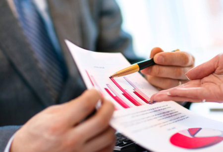 Image of human hand pointing at paper during explanationの写真素材