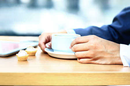 Businesswoman with tablet computer reading news at morning in cafe shopの写真素材