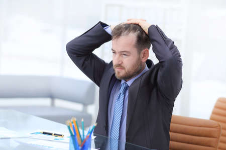 Satisfied businessman relaxing in his modern officeの写真素材