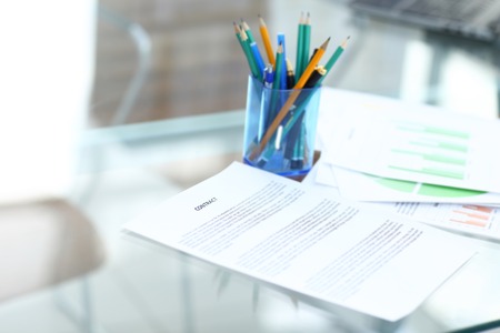 Business man signing a contract in modern light office