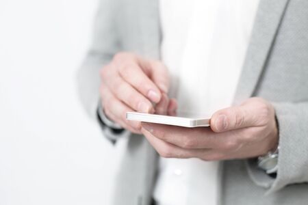 Close up of a man using mobile modern smart phoneの写真素材