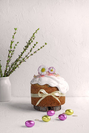 Easter Cake decorated with meringue and flowers on white background and white table with copy space....