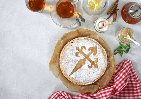 tarta de santiago and tea cups, spanish almond cake, top view, copy spaceの写真素材