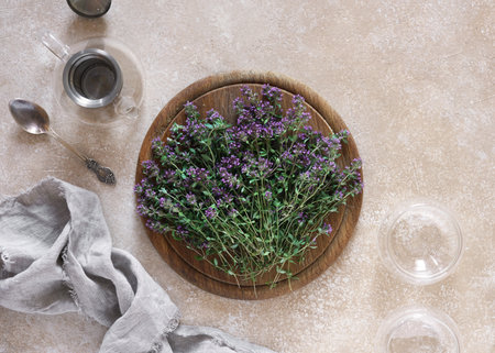 Thymus serpyllum, Thyme on wooden desk with empty teapot and cups, top view, copy spaceの写真素材