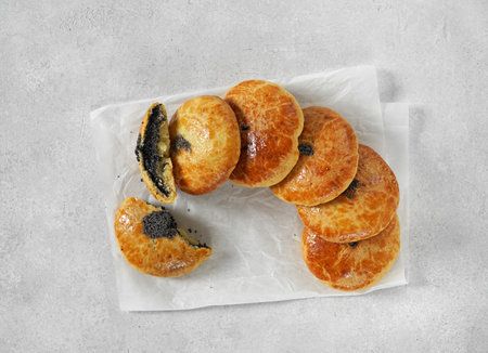 Traditional Christmas Austrian pies Mohnzelten with poppy seeds filling on light table, top viewの写真素材