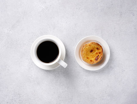 pastel de nata with cup of coffee on concrete background, top view, copy space, breacfast concept