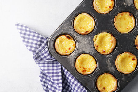Pasteis de nata in the cooking form. Top view, copy space