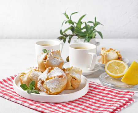 Soffioni - traditional ricotta cheese and lemon cakes. Concept of sweet and easter national pastries. Breakfast conceptの写真素材