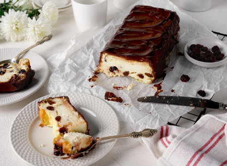 Lviv cheesecake, a traditional Ukrainian dessert with raisins, coated with chocolate icingの写真素材