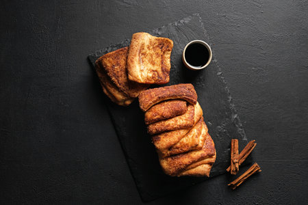 Cinnamon slices bread with cup of espresso. Homemade pastry for breakfast. top view, black...