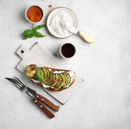 Delicious bruschetta with ricotta, grilled zucchini and herbs on a ceramic board top view web bannerの写真素材