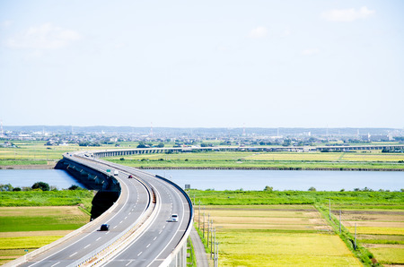 Highway and Paddy Field in Harvest Season (Sawara, Chiba, Japan)の写真素材