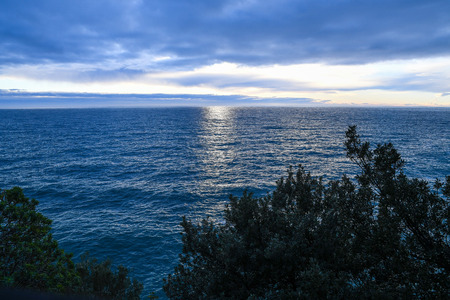 The setting Sun of Ligurian Sea from Riomaggiore, Cinque Terre (5 Terre), Five village on the Italian Riviera, Liguria, Italyの写真素材