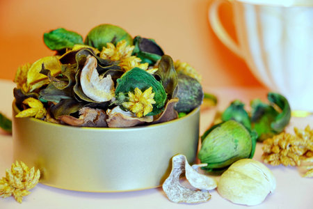 Herbal tea with fruit on an orange background next to the cup. Macro photographyの写真素材