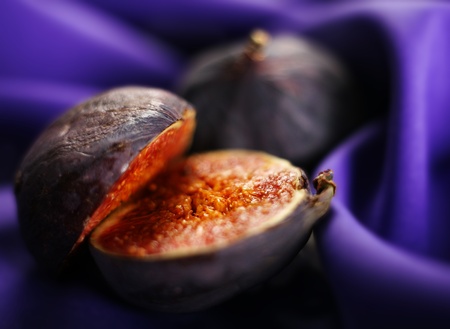 Ripe raw fig fruit close-up on blue backgroundの写真素材