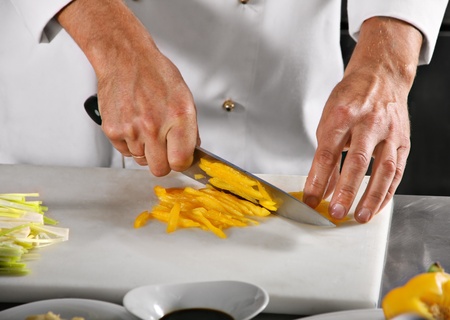 Chef carving pepper on professional kitchen in restaurantの写真素材