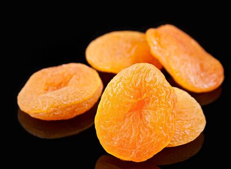 Yellow dried fruit apricot closeup on blackの写真素材