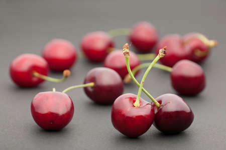 Red cherry fruit closeup on dark backgroundの写真素材