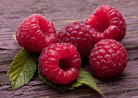 Raspberry fruit closeuo on old wood background