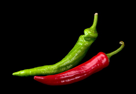 Red and green chili pepper isolated on blackの写真素材