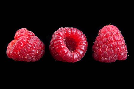 Sweet raspberry fruit isolated on black background