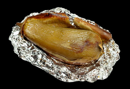 Fried eggplant vegetable in foil isolated on blackの写真素材