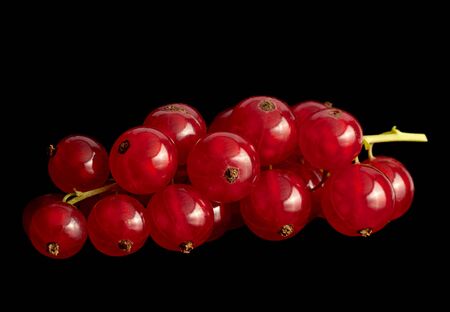 Red currant berry with leaf isolated on black backgroundの写真素材
