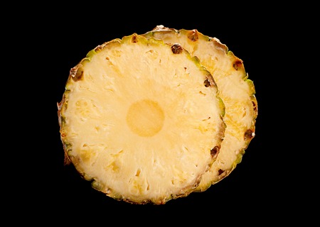 Pineapple fruit slice isolated on black backgroundの写真素材