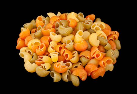 Multicolor dry swirl pasta isolated on black backgroundの写真素材