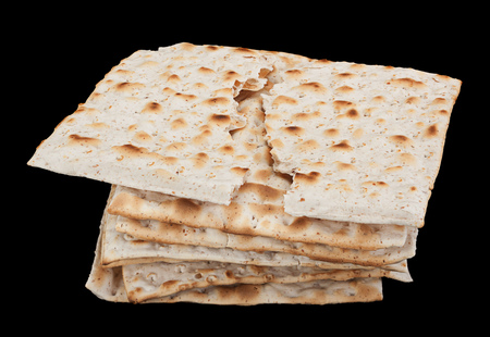 Matzo traditional jewish bread isolated on blackの写真素材