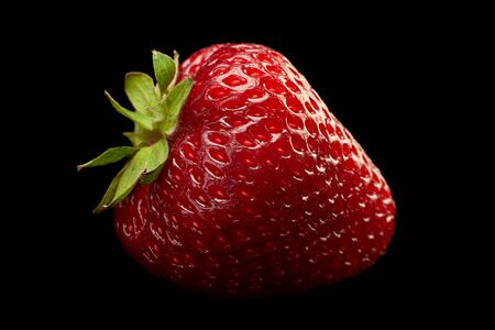 Strawberry fruit closeup isolated on black backgroundの写真素材