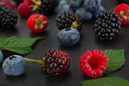 Mix berry with blackberry closeup isolated on black backgroundの写真素材