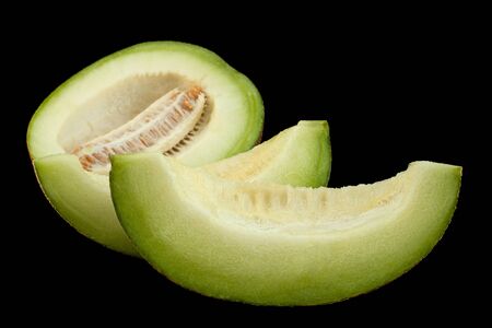 Ripe melon fruit colseup isolated on black backgroundの写真素材