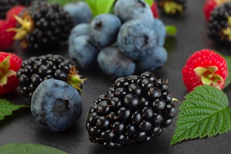 Mix berry with blackberry closeup isolated on black backgroundの写真素材