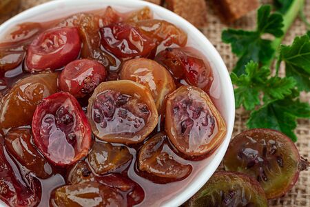 Red Gooseberry jam with berry closeup viewの写真素材