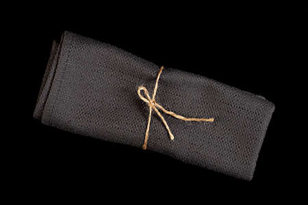 Black tablecloth closeup isolated on black background