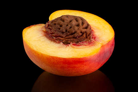Ripe nectarine fruit isolated on black backgroundの写真素材