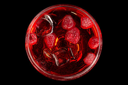 Cocktail with raspberry and ice on blackの写真素材