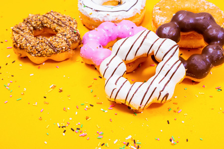 Colorful Donuts on yellow  background.の写真素材