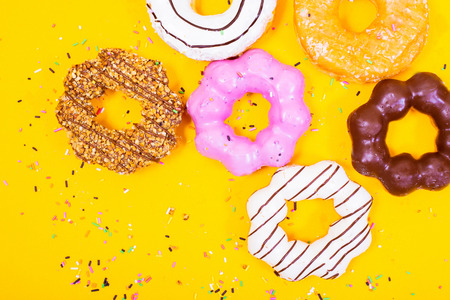 Colorful Donuts on yellow  background.の写真素材