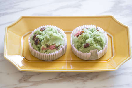 two steamed cakes with red beans on plate