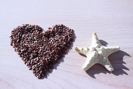 Starfish and heart from flax seeds  Two objects lie on a tree 