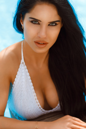 young beautiful girl in swimsuit near the poolの写真素材