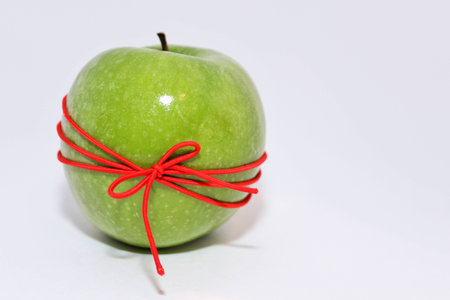 green apple with red bowの写真素材