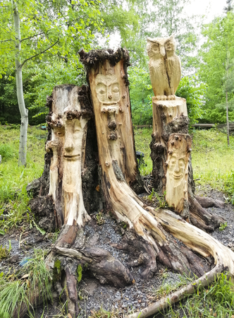 face carved from wood. wood decor in the park.の写真素材