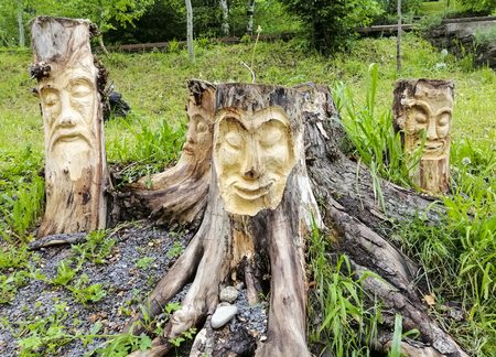 face carved from wood. wood decor in the park.の写真素材