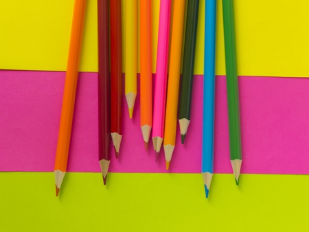 multi-colored pencils lie on a multi-colored backgroundの写真素材