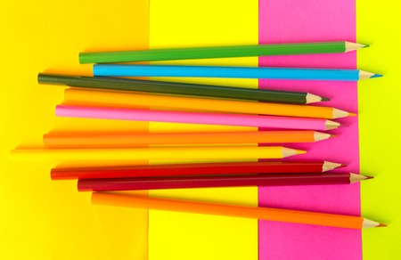 multi-colored pencils lie on a multi-colored backgroundの写真素材