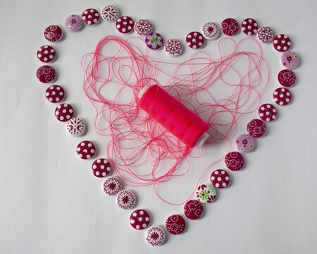 tools for sewing and needlework. hobby. multi-colored sewing thread. heart of buttons